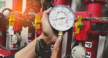 pressure gauges of gas pipe in hand of maintenance man