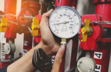 pressure gauges of gas pipe in hand of maintenance man
