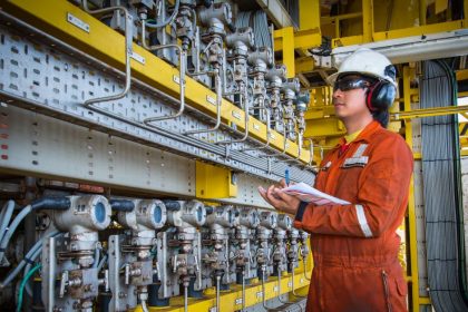 Technician observing industrial electrical equipment to be calibrated