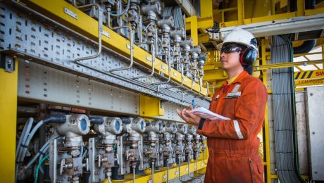 Technician observing industrial electrical equipment to be calibrated