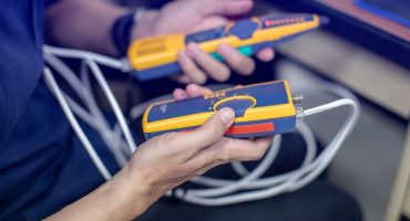 Network cable tester. Testing structured cabling using qualified cable performance tester. UTP cable with RJ45 jack checking with digital cable tools.