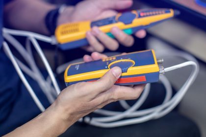 Network cable tester. Testing structured cabling using qualified cable performance tester. UTP cable with RJ45 jack checking with digital cable tools.