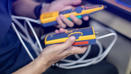 Network cable tester. Testing structured cabling using qualified cable performance tester. UTP cable with RJ45 jack checking with digital cable tools.